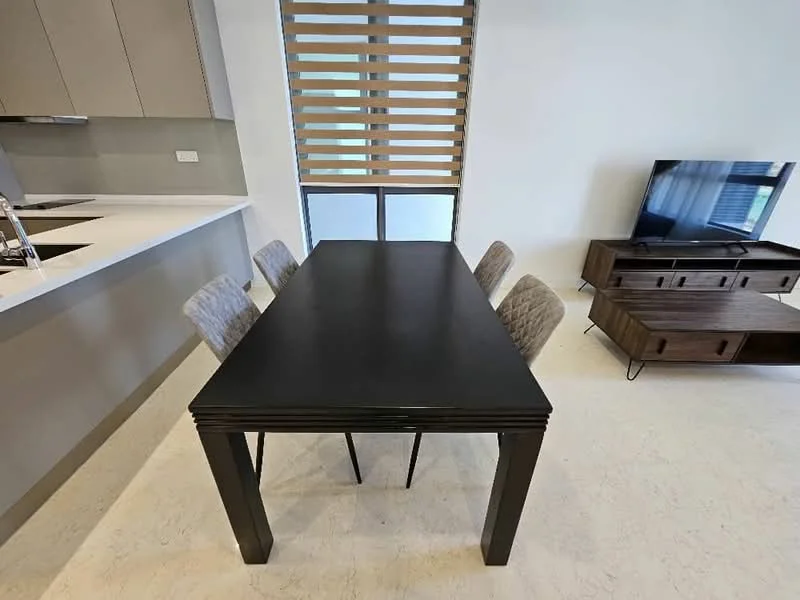 Dining features: black rectangular dining table, 4 upholstered dining chairs, light grey fabric upholstery on chairs, large window with horizontal wooden blinds, white walls, light-colored flooring, TV console with storage, wall-mounted TV; style: modern.