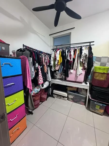 Room features: white painted walls, grey tile flooring, 5-blade ceiling fan, clothing rack with hanging clothes, colorful storage drawers in purple, orange, and blue, plastic storage bins, open shelving unit, window with natural light; style: modern.