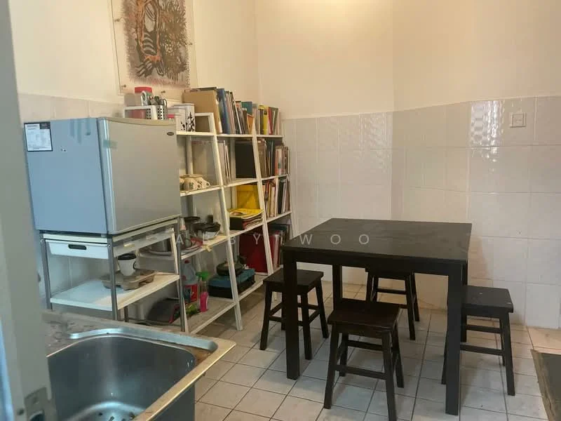Kitchen features: white tiled walls, ceramic tile flooring, black square dining table, four wooden stools, stainless-steel fridge, open shelving unit, various books and items on shelves, sink with chrome faucet.