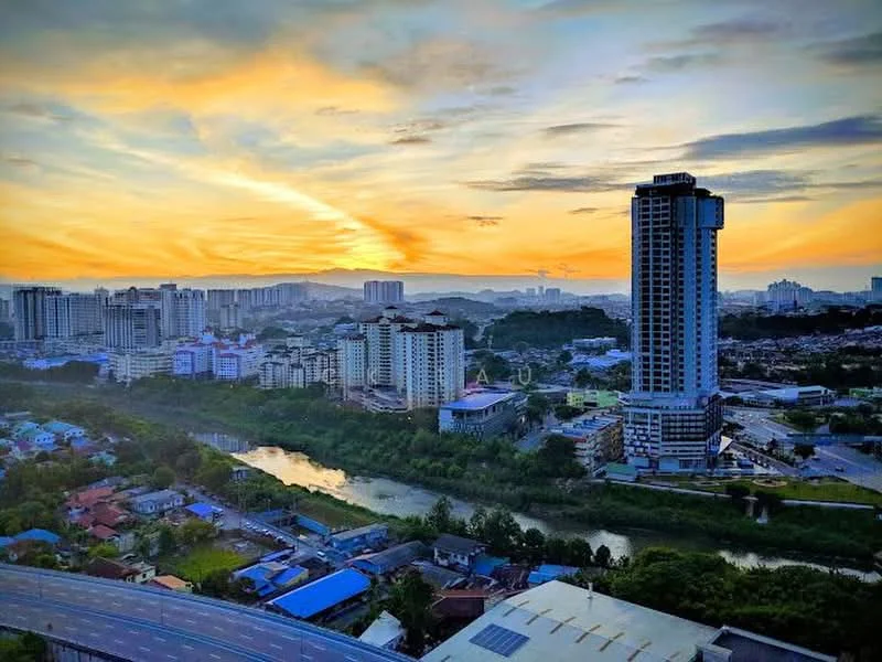 Exterior type: high-rise condominium; features: city skyline view, river view, sunset, surrounding low-rise buildings, urban landscape, greenery along the riverbank; style: modern.