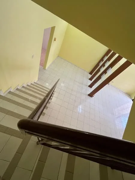 Room features: yellow painted walls, white tiled flooring, wooden handrail, staircase with tiled steps, large windows allowing natural light, open space, wooden support beams; style: modern.