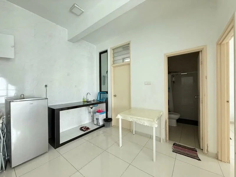 Room features: white painted walls, polished ceramic tile flooring, single-bowl stainless-steel sink, chrome pull-down faucet, black countertop, stainless-steel fridge, wooden table with white tablecloth, door leading to bathroom, door leading to another room, window with no visible treatment, waste bin; style: modern.