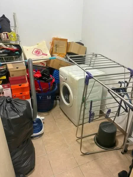 Laundry features: front-load washing machine, clothes drying rack, plastic laundry baskets, storage boxes, black garbage bag, various shoes in boxes, tile flooring, white walls.