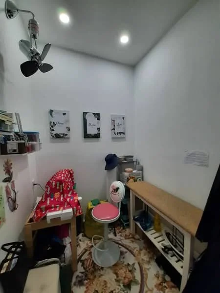 Room features: white painted walls, recessed LED downlights, 5-blade ceiling fan, decorative wall art, wooden bench, stool with backrest, carpet with floral pattern, storage shelves, various items on shelves; style: modern.