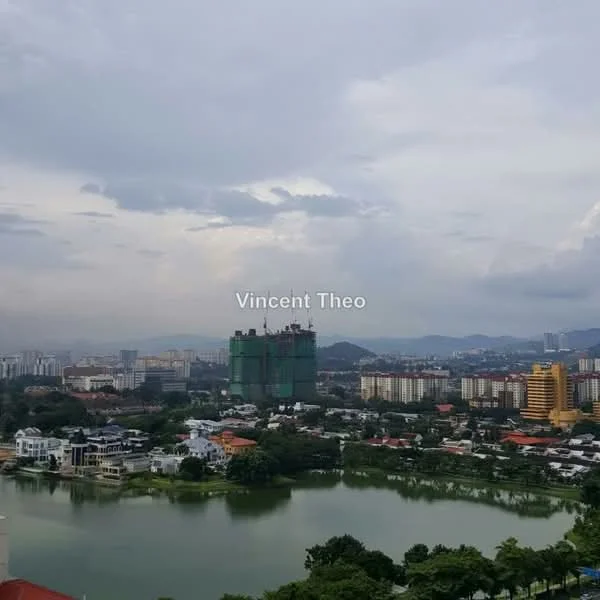 Exterior type: high-rise condominium; features: city skyline view, surrounded by greenery, waterfront view, construction site visible, mixed residential and commercial buildings, hills in the background; style: modern.