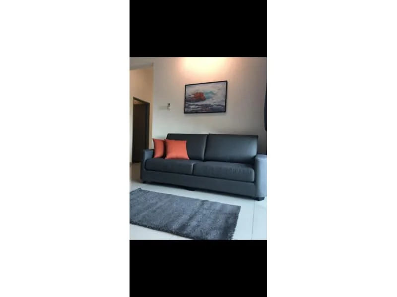 Living features: 3-seater fabric sofa in grey, orange accent pillows, area rug with grey color, framed artwork on wall, white painted walls, tile flooring, recessed downlights; style: modern.