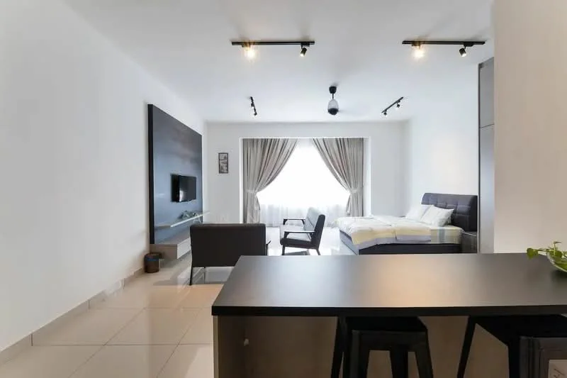 Living features: white painted walls, tile flooring, recessed downlights, 5-blade ceiling fan, floor-to-ceiling window, sheer curtains, wall-mounted TV, grey upholstered bed, black coffee table, black bar stools, dark wood feature wall, armchair, decorative plant; style: modern.