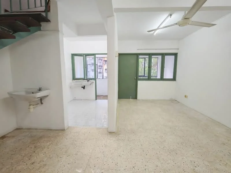 Living features: white painted walls, tile flooring, ceiling fan, large windows with green frames, open layout, door leading to another room, sink, light fixture. Kitchen features: white painted walls, tile flooring, sink, window with green frame.