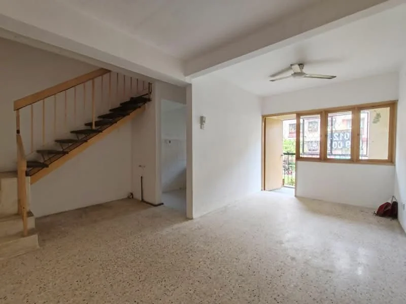 Living features: white painted walls, exposed ceiling beams, ceiling fan, large windows, balcony access, terrazzo flooring, staircase leading to upper floor, natural light; style: minimalist. Room features: white painted walls, terrazzo flooring, staircase, doorway leading to another room.