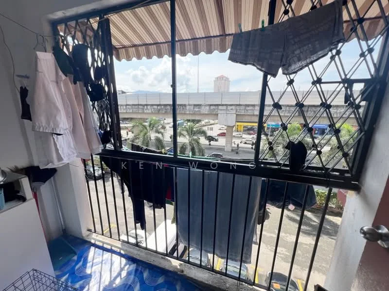 Laundry features: metal window grille, striped awning, clothes drying rack, hanging clothes, blue patterned flooring, view of street, view of palm trees, view of vehicles; view: city.