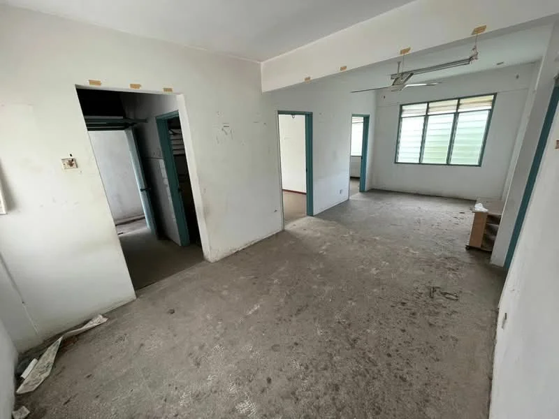 Room features: plain white walls, concrete flooring, single ceiling fan, multiple doorways, large window with green view, unpainted wall sections, no visible furniture, neutral color scheme; style: minimalist.