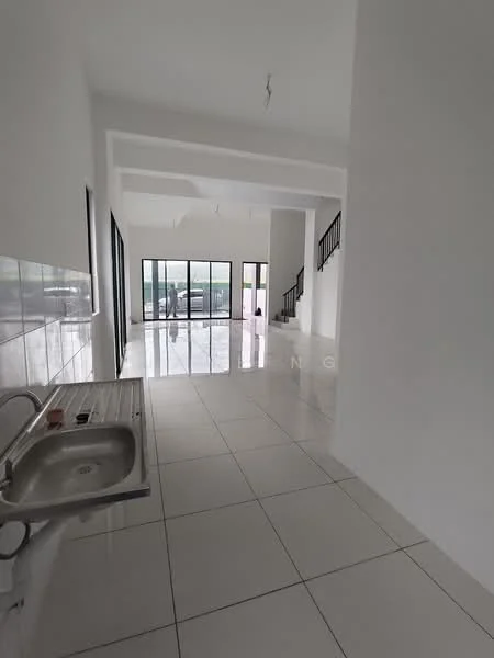 Room features: white painted walls, glossy white tile flooring, single-bowl stainless-steel sink, stainless-steel countertop, large floor-to-ceiling windows, open layout, high ceiling, staircase visible in background; style: modern; view: garden.