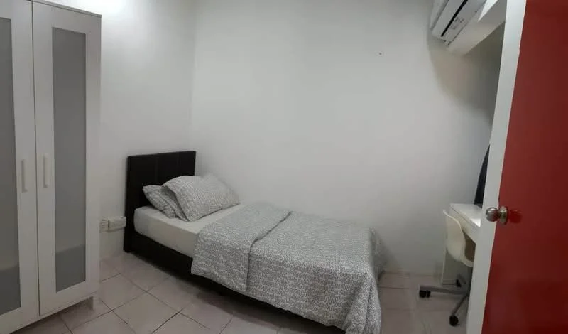 Bedroom features: single bed with grey bedding, upholstered headboard, white wardrobe with glass panels, study desk with chair, wall-mounted air conditioning unit, white painted walls, tile flooring, window with no visible treatment; style: modern.