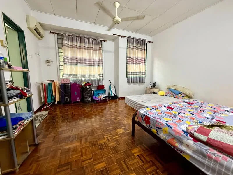 Bedroom features: wooden flooring, white painted walls, 2 windows with sheer curtains, 5-blade ceiling fan, 1 wall-mounted split AC, double bed with floral bedding, single bed with colorful bedding, built-in wardrobe, clothes rack, decorative wall art.