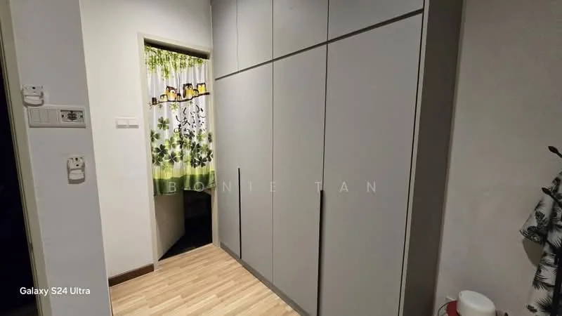 Room features: built-in wardrobe with sliding doors, light wood laminate flooring, green floral curtain, white walls, doorway leading to another room; style: modern.
