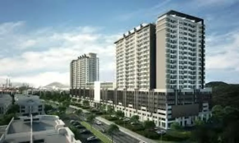 Exterior type: high-rise condominium; features: glass curtain wall, exposed concrete facade, projecting balconies, manicured lawn, surrounded by greenery, multi-storey car park, driveway with interlocking pavers, urban context with skyline view in background; style: modern.