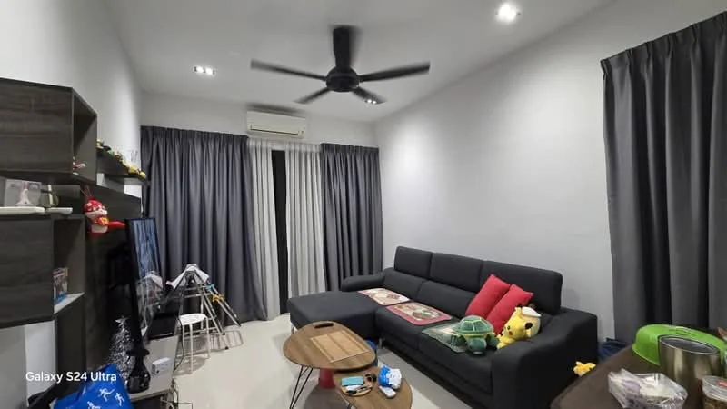 Living features: grey painted walls, white ceiling, 5-blade ceiling fan with light, floor-to-ceiling windows with sheer curtains, black fabric sofa with red and green cushions, wooden coffee table, TV console, decorative toys on shelves, area rug, laminate flooring; style: modern.