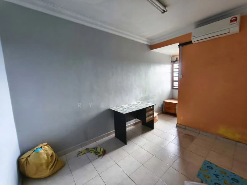 Room features: grey painted walls, orange painted wall, tile flooring, window with security bars, 1 wall-mounted split AC, desk with patterned top, wooden chest of drawers, bean bag, area rug with pattern.