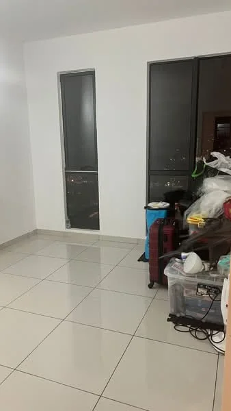 Room features: white painted walls, large windows with dark frames, grey tiled flooring, city view visible through windows, cluttered with various items including luggage and household goods; view: city.