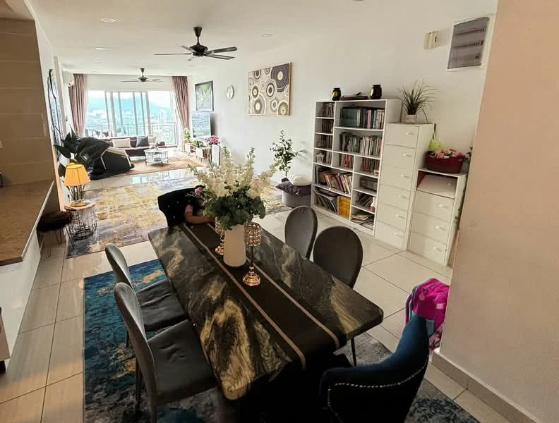 Dining features: 6-seater dining table with marble top, upholstered dining chairs in grey and blue, decorative vase with flowers, pendant lighting above table, area rug with geometric pattern, wall-mounted clock, open shelving unit with books, large windows with city view, ceiling fan, neutral painted walls, tile flooring; style: modern; view: city. Living features: sofa with cushions, coffee table, area rug, bookshelves, large windows with city view, ceiling fan, neutral painted walls, tile flooring; style: modern; view: city.