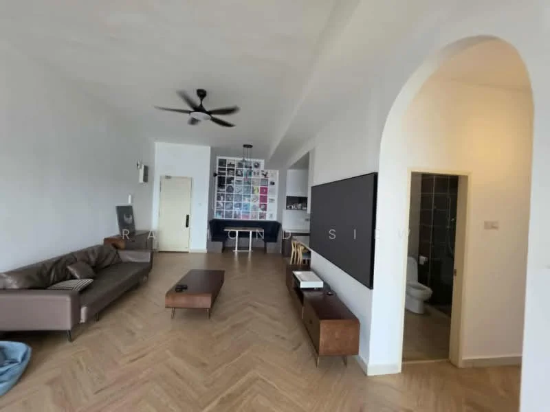 Living features: 3-seater leather sofa in brown, coffee table, wall-mounted TV, ceiling fan, wooden flooring, decorative wall with framed artwork, open layout, arched doorway, neutral painted walls; style: modern. Room features: door leading to bathroom, dark tiled wall, toilet visible.