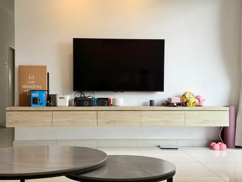 Living features: wall-mounted flat-screen TV, light wood TV console, white walls, glossy white tile flooring, round marble coffee table, decorative items on console, pink plush toy, black storage boxes, framed wall art, decorative figurines; style: modern.