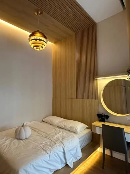 Bedroom features: queen-size bed with white bedding, wood paneling on walls, recessed lighting, round mirror with light, wooden desk, black chair, pendant light fixture, laminate flooring; style: modern.