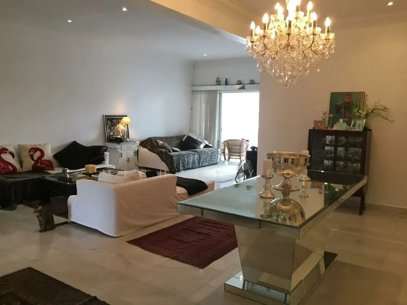 Living features: chandelier, white painted walls, marble flooring, sofa with patterned upholstery, 2-seater white sofa, decorative cushions with flamingo pattern, glass dining table with metallic base, wooden cabinet, area rug, floor-to-ceiling windows, curtains, decorative artwork, houseplants in pots; style: contemporary.