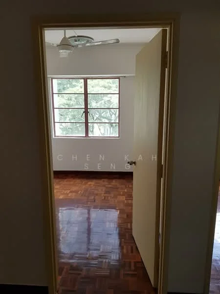 Room features: wooden flooring, white painted walls, ceiling fan, window with grid design, door with yellow frame, natural light from window, view of greenery outside; view: garden.
