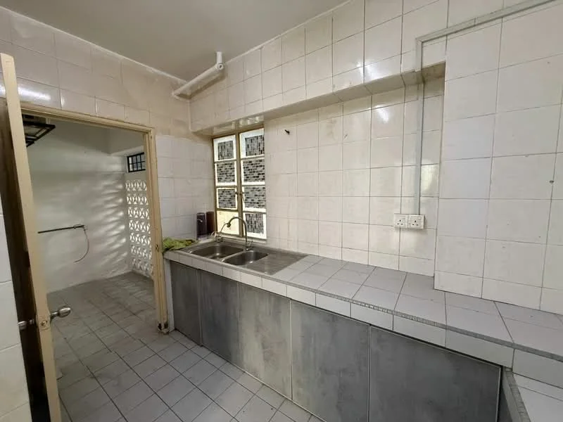 Kitchen features: double-bowl stainless-steel sink, chrome pull-down faucet, grey laminate countertop, white tiled backsplash, white tiled walls, grey ceramic tile flooring, wooden door, window with grid pattern, open shelving, built-in cabinets.