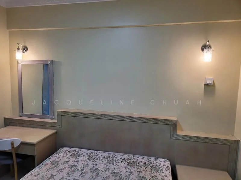 Bedroom features: queen-size bed with floral bedding, wooden headboard, wall-mounted mirror, desk with chair, wall sconces for lighting, cream painted walls, wooden paneling, decorative ceiling, flooring not visible.