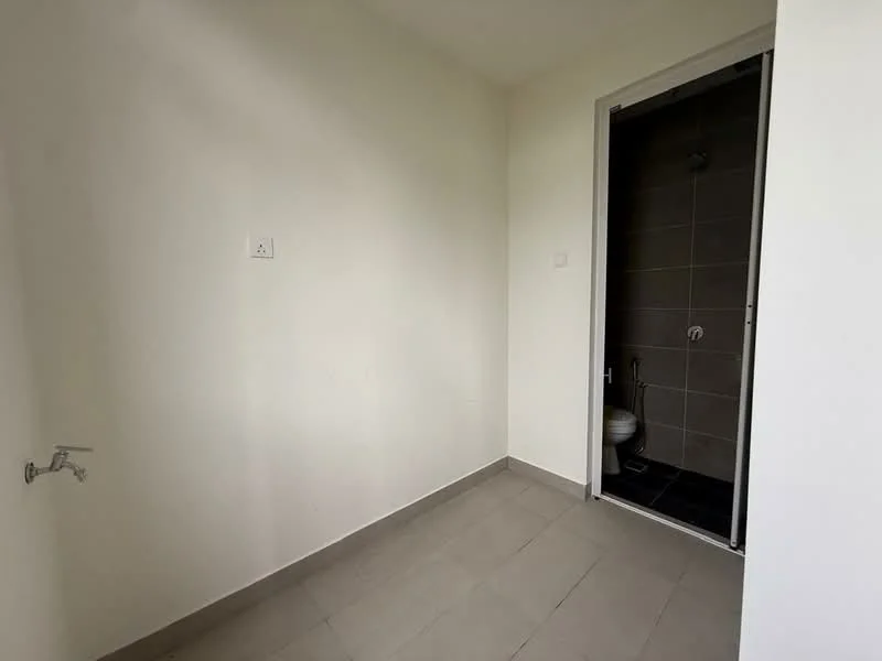 Room features: white painted walls, grey tiled flooring, shower area with grey tile cladding, wall-mounted faucet, toilet visible in shower area, door leading to shower area.