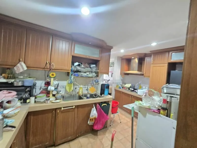 Kitchen features: wood cabinetry, granite countertop, stainless-steel sink, chrome pull-down faucet, built-in oven, freestanding range oven, microwave, dishwasher, tile backsplash, ceramic tile flooring, recessed downlights, open shelving, kitchen island, wall-mounted cabinets; style: traditional.