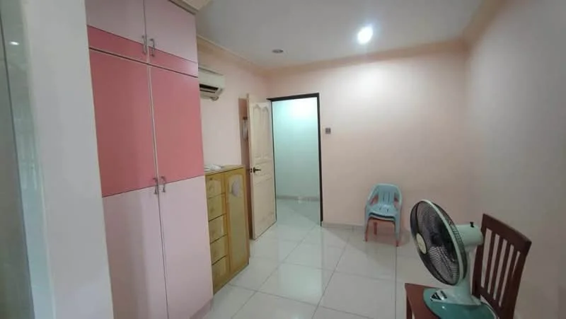 Room features: pink cabinetry, wooden cabinet, white tiled flooring, cream painted walls, ceiling light, wall-mounted air conditioning unit, plastic chair, wooden dining chair, table fan; style: modern.