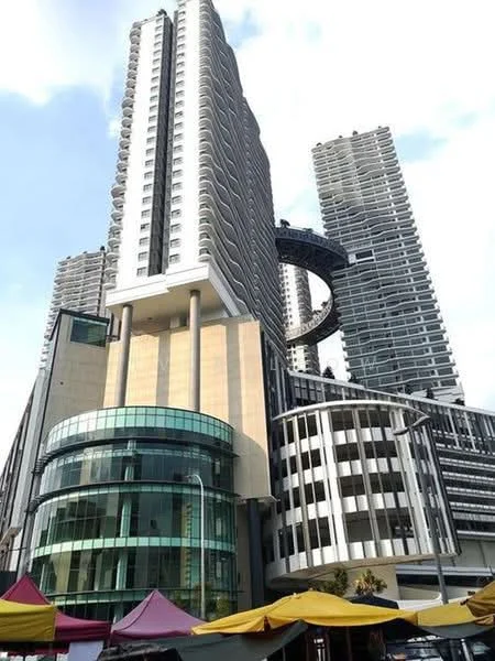 Exterior type: high-rise condominium; features: glass curtain wall, exposed concrete facade, recessed balconies, multiple storeys, curved architectural feature, outdoor market stalls in foreground; style: modern.