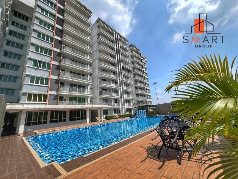 Exterior type: high-rise condominium; features: swimming pool, pool deck with loungers, glass curtain wall facade, white painted facade, balconies on upper floors, landscaped garden area, tropical landscaping with palm trees, manicured lawn; style: modern.