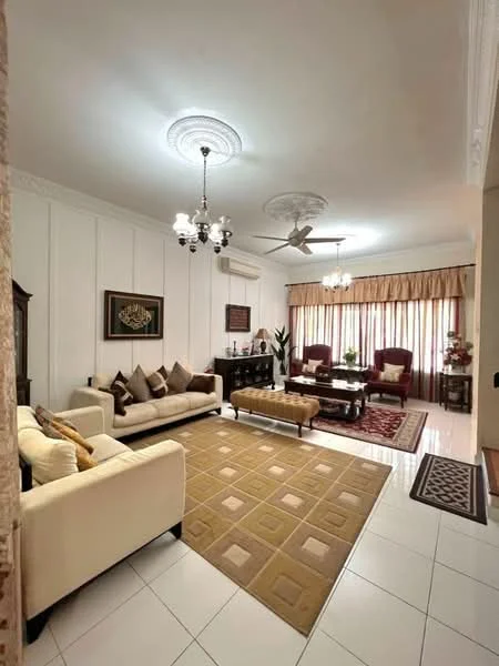 Living features: cream painted walls, white ceiling with crown moulding, 5-blade ceiling fan with light, chandelier, large windows with sheer curtains, brown area rug with geometric pattern, beige 3-seater fabric sofa, brown armchairs with cushions, wooden coffee table, dark wooden sideboard, decorative plants, framed artwork on wall, wall-mounted air conditioning unit; style: traditional.