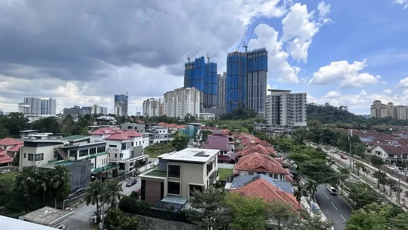 Exterior features: city skyline, high-rise buildings under construction, residential houses with red roofs, green landscaping, tree-lined streets, urban setting, mixed architectural styles; style: modern.