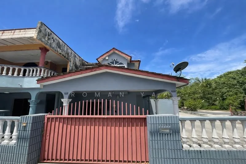 Exterior type: detached bungalow; features: red painted gate, grey painted facade, arched windows, gabled roof, satellite dish, front porch with columns, manicured lawn, paved driveway, surrounding greenery; style: traditional.