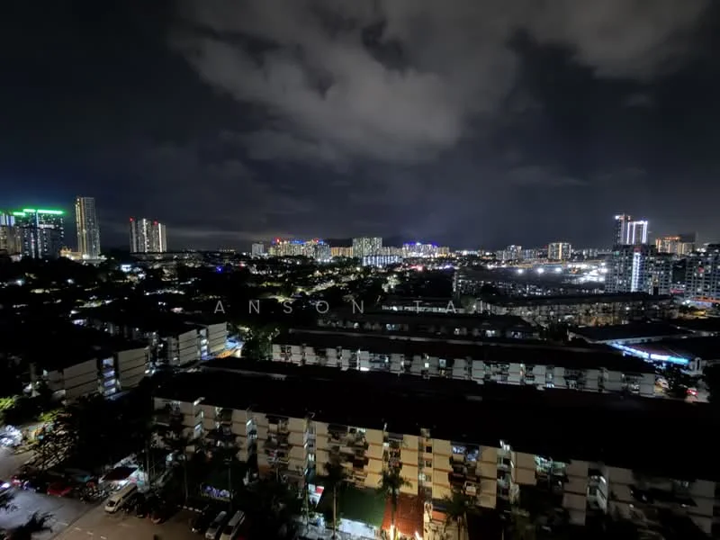 Exterior type: high-rise condominium; features: night city skyline view, multiple high-rise buildings, illuminated buildings, surrounding greenery, parking area visible, street lights, cloudy night sky; style: modern.