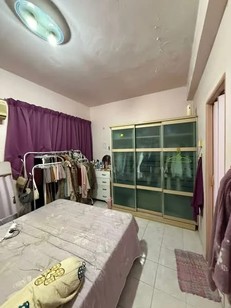 Bedroom features: queen-size bed with light bedding, wooden wardrobe with glass doors, white painted walls, tile flooring, curtains in dark purple, 1 wall-mounted split AC, dressing table, clothing rack with hangers, area rug in light color, ceiling light fixture.