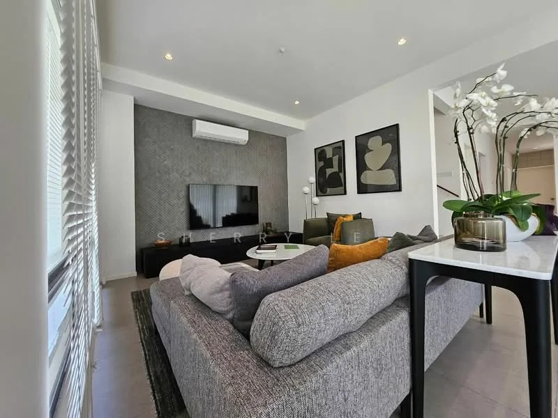 Living features: grey fabric sectional sofa, black coffee table, wall-mounted TV, textured accent wall with geometric pattern, recessed ceiling lights, floor-to-ceiling windows with sheer curtains, decorative indoor plants, area rug with geometric pattern, decorative vases, white side table, black and white artwork on walls; style: modern.