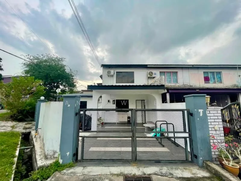 Exterior type: semi-detached house; features: white painted facade, black metal roof, front gate with metal fencing, paved driveway, manicured lawn, outdoor seating area, air conditioning units visible, decorative plants in pots, exterior wall with white tiles, overcast sky; style: modern.