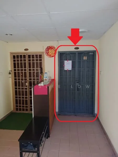 Room features: grey metal security door, wooden reception counter, green carpet mat, cream painted walls, tile flooring, ceiling lights, decorative wall hanging, notice on door; style: modern.