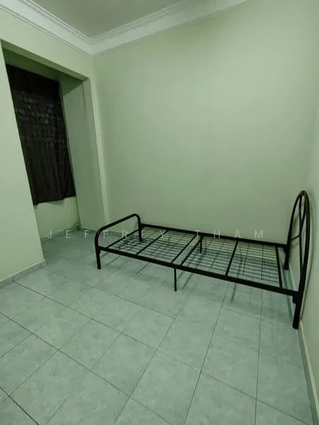 Bedroom features: green painted walls, tile flooring, single metal bed frame, window with black curtains, crown moulding, light fixture on ceiling.