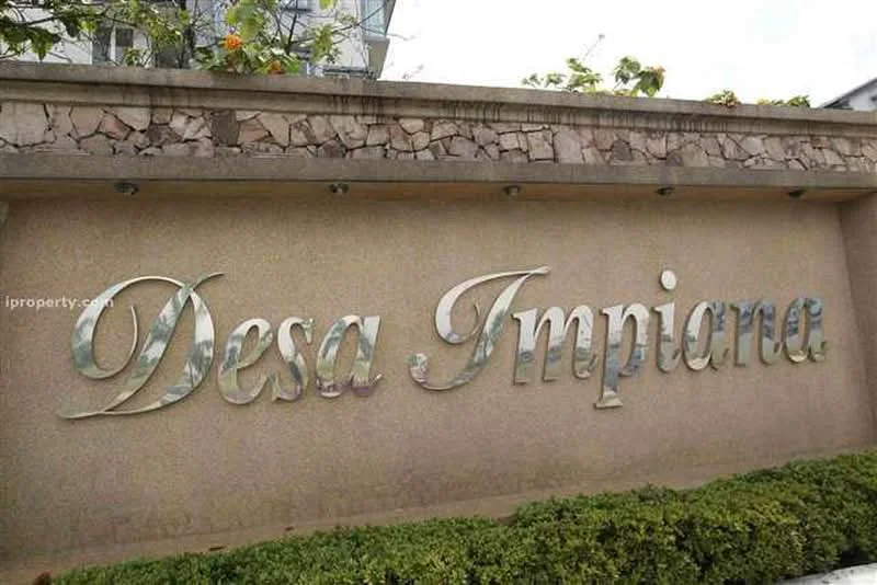 Exterior type: main entrance gate; features: stone-clad wall, metal signage with reflective finish, landscaped greenery, manicured hedges, decorative lighting fixtures, surrounding foliage; style: modern.