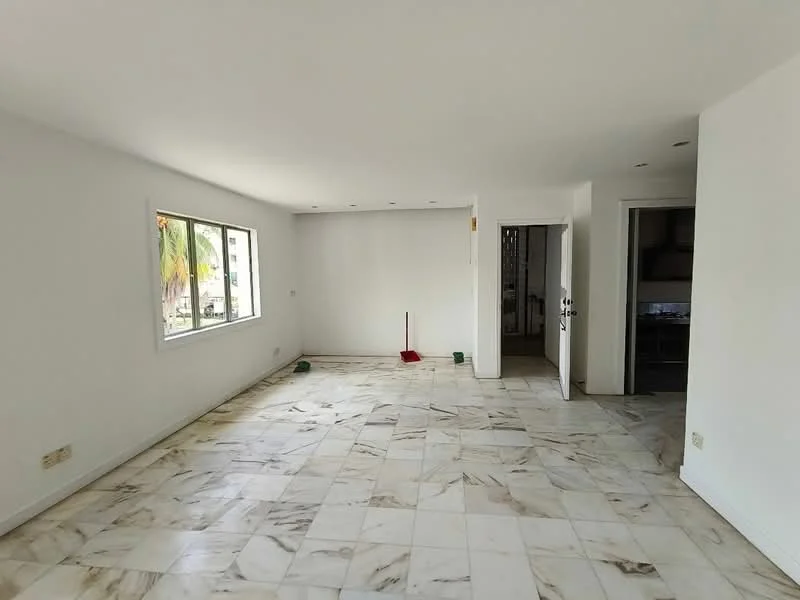 Living features: white painted walls, marble tile flooring, large window with natural light, recessed downlights, open layout, neutral color scheme, no visible furniture, clean and uncluttered space; style: modern; view: garden.