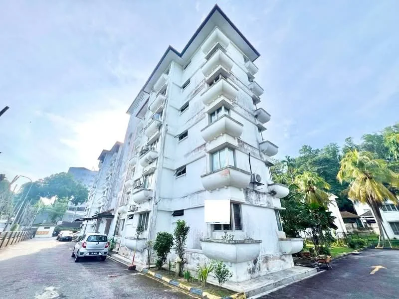 Exterior type: low-rise apartment block; features: white painted facade, recessed balconies, approximately 4-storey building, surrounded by greenery, paved driveway, parking space visible; style: modern.