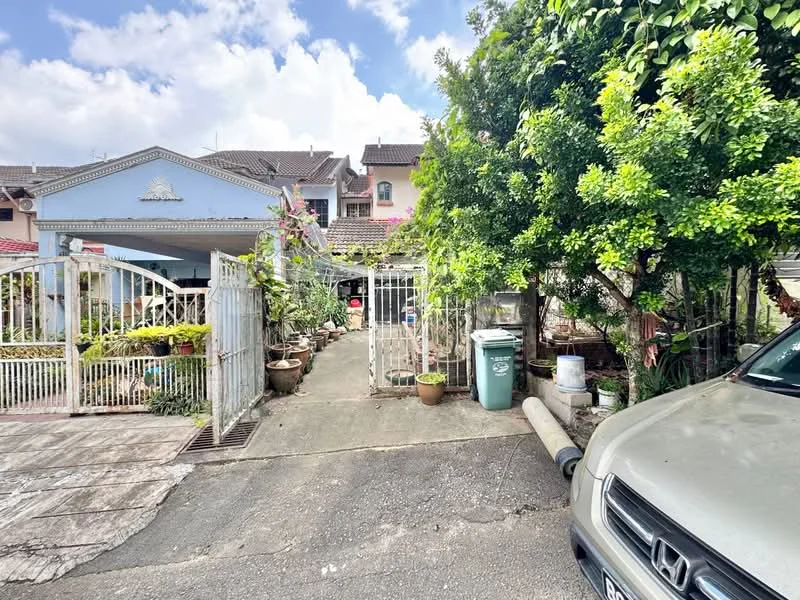 Exterior type: linked terrace house; features: white painted facade, gated entrance, manicured garden, paved driveway, mature trees, flower pots, fence, car parked in driveway; style: traditional.