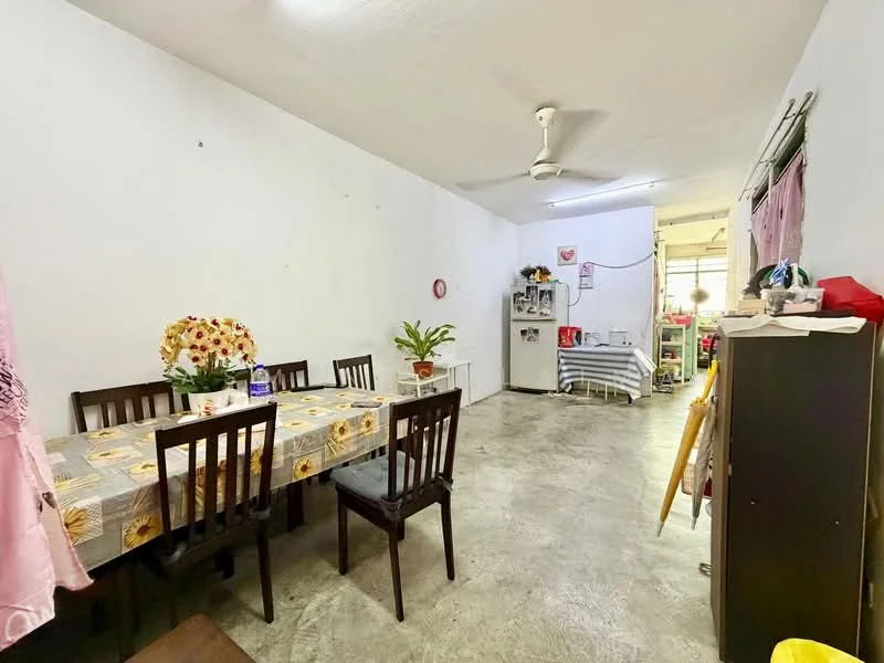 Dining features: dining table with floral tablecloth, 8 dining chairs, white painted walls, concrete flooring, ceiling fan, decorative wall clock, potted plant, window with natural light; style: minimalist. Living features: sofa, side table, shelves with decorative items, visible kitchen area, window with natural light; style: minimalist.